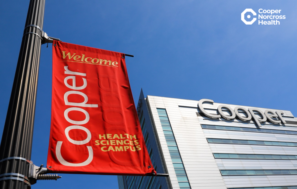 Cooper campus banner and Roberts Pavilion with Cooper Norcross Health logo